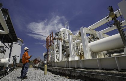 Male worker inspection at steel long pipes and pipe elbow in sta Male worker inspection at steel long pipes and pipe elbow in station oil factory during refinery valve of visual check record pipeline oil and gas industry